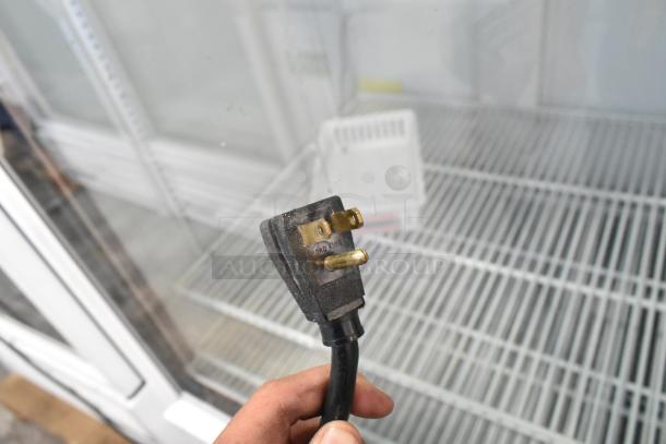 True GDM-12 metal commercial cooler with single glass door, poly-coated racks, and visible power plug. 115V, 1 phase.