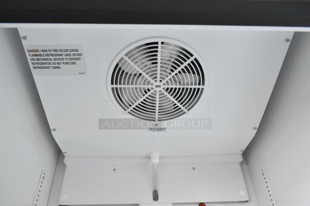 2021 True TSCI-600R-G-PH commercial cooler interior, showing ventilation fan and warning label.