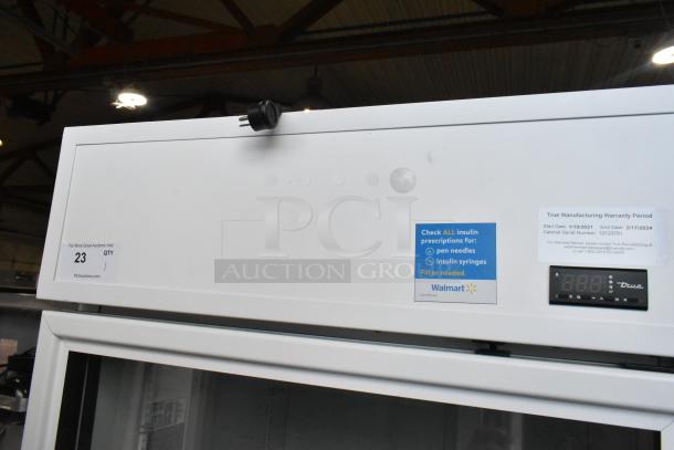 2021 True TSCI-600R-G-PH commercial cooler, single door, glass front. Includes labels: warranty info, Walmart status. 115V, 1 phase.