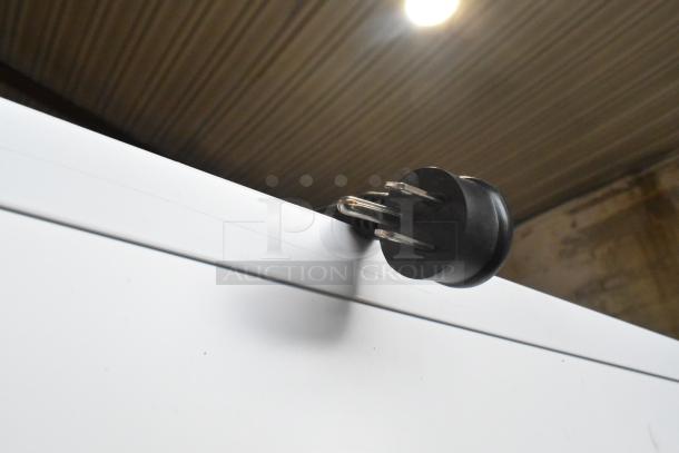 2021 True TSCI-600R-G-PH commercial cooler with poly-coated racks, 115V, 1 phase. Image shows top corner detail with power cord plug.