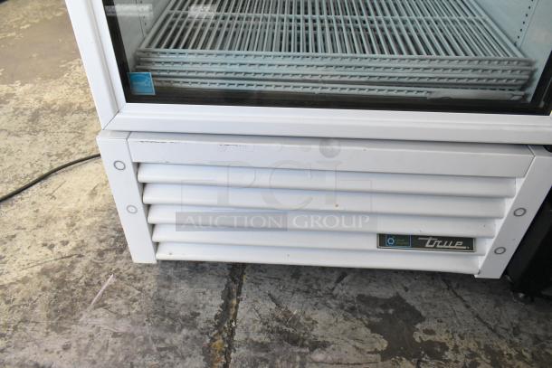 2021 True TSCI-600R-G-PH single door cooler merchandiser, poly coated racks, 115V, good condition, visible brand label.