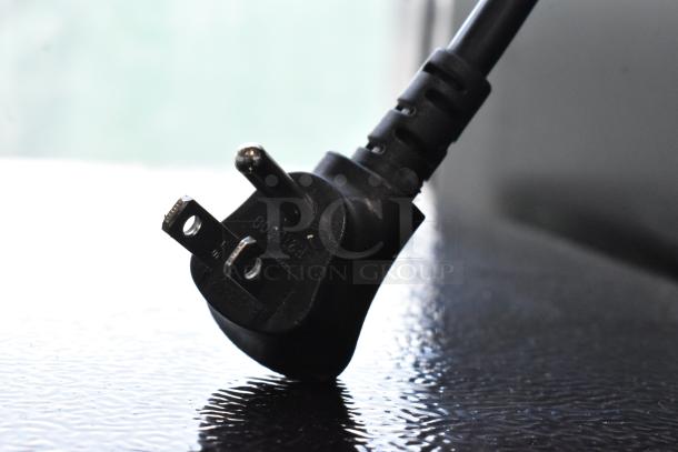 Close-up of a black electrical plug for Hisense RR33D6ABE and Galanz GLR31TS1E02 mini coolers, 115V, 1 phase.