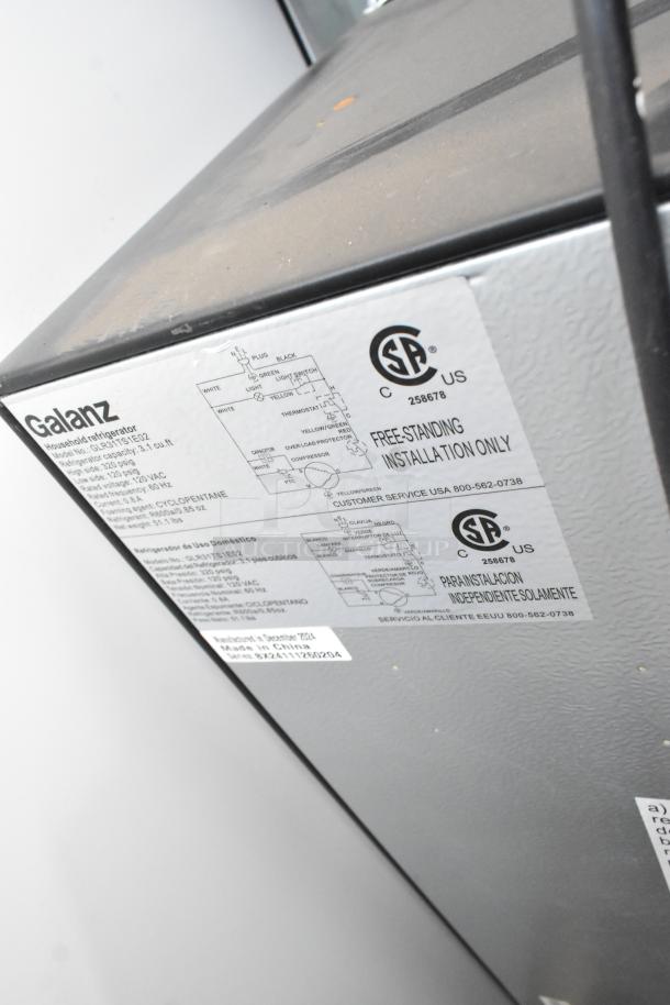 Galanz GLR31TS1E02 Mini Cooler with Freezer. 115 Volts. Label shows specifications and installation instructions.