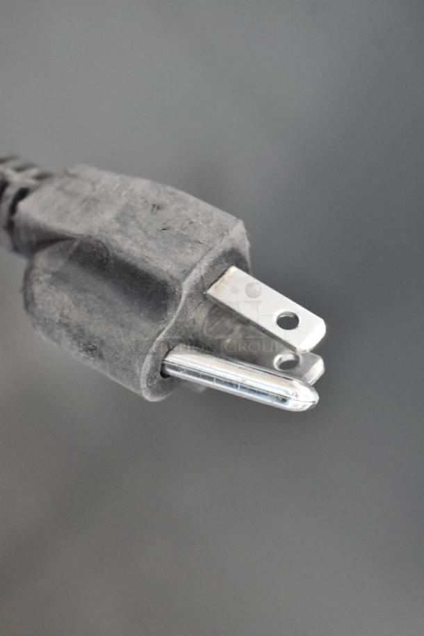 Close-up of a three-prong electrical plug for the Frigidaire EFRF698-6COM freezer. Suitable for 115 volts, 1 phase.