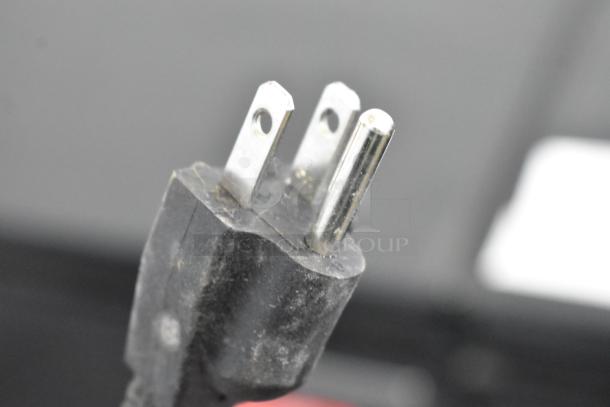 Close-up of a plug from a Frigidaire FGFRF7009-B-BLACK chest freezer, 115 Volts, 1 Phase, in used condition.