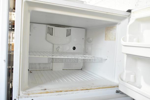 Frigidaire FRT21S6AWH metal cooler with freezer, showing interior condition and shelving, 115 volts, 1 phase.