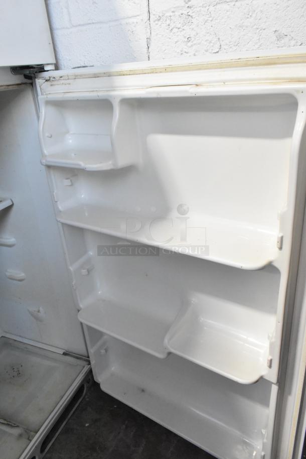 Frigidaire FRT21S6AWH metal cooler with freezer, interior view. Features shelving; runs on 115 volts, 1 phase.