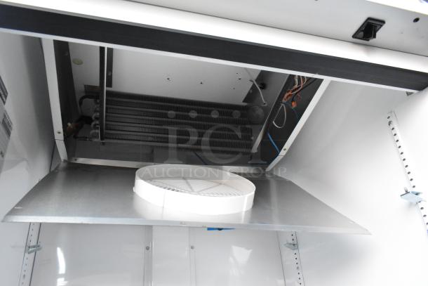 2021 True TSCI-600R-G-PH metal commercial cooler interior, showing coils and fan. Poly-coated racks included. 115V, 1 Phase.