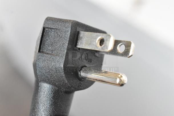 Close-up of a power plug from a Hamilton Beach HBFRF3030-3BCOM chest freezer, showing 115V, 1-phase design.