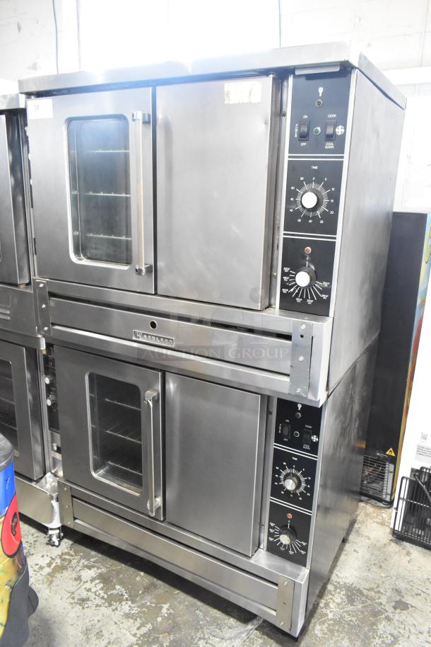 2 Garland stainless steel commercial convection ovens with view-through and solid doors, metal racks, thermostatic controls.