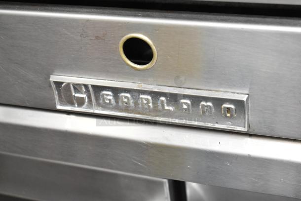 Garland stainless steel convection oven with view-through door, metal racks, thermostatic controls; logo plate visible.