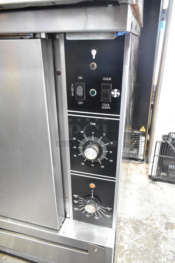 2 Garland stainless steel commercial full-size convection ovens with view-through door, metal racks, thermostatic controls.