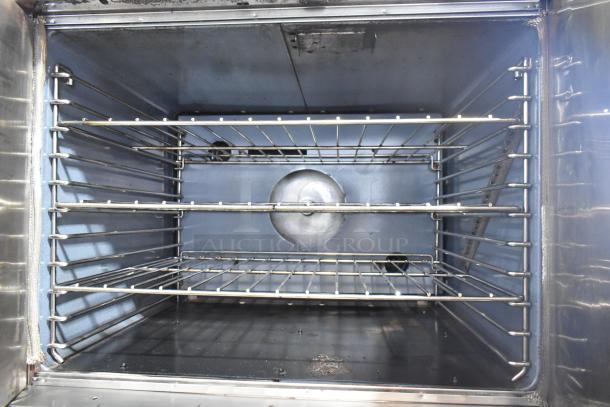 2 Garland stainless steel commercial convection ovens with view-through and solid door, metal racks, and thermostatic controls.