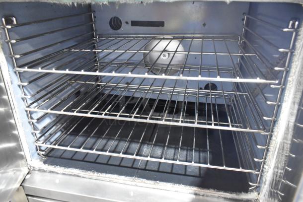 2 Garland stainless steel full-size convection ovens with view-through door, metal racks, thermostatic controls.