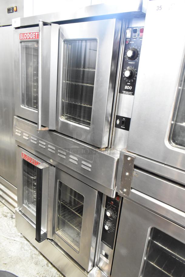 Blodgett stainless steel gas convection ovens with view-through doors, metal racks, and thermostatic controls on casters.