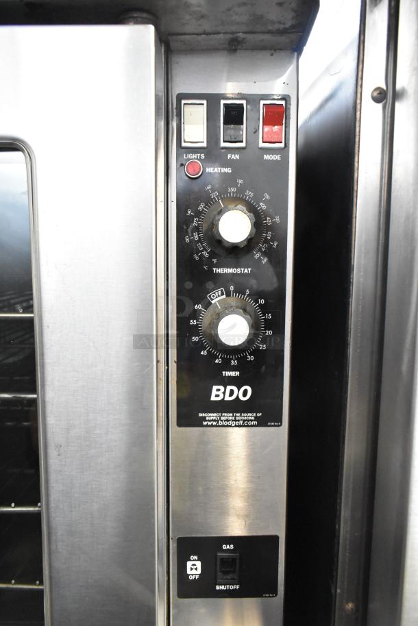 Blodgett stainless steel gas convection oven with view-through doors, metal racks, thermostatic controls, and casters.