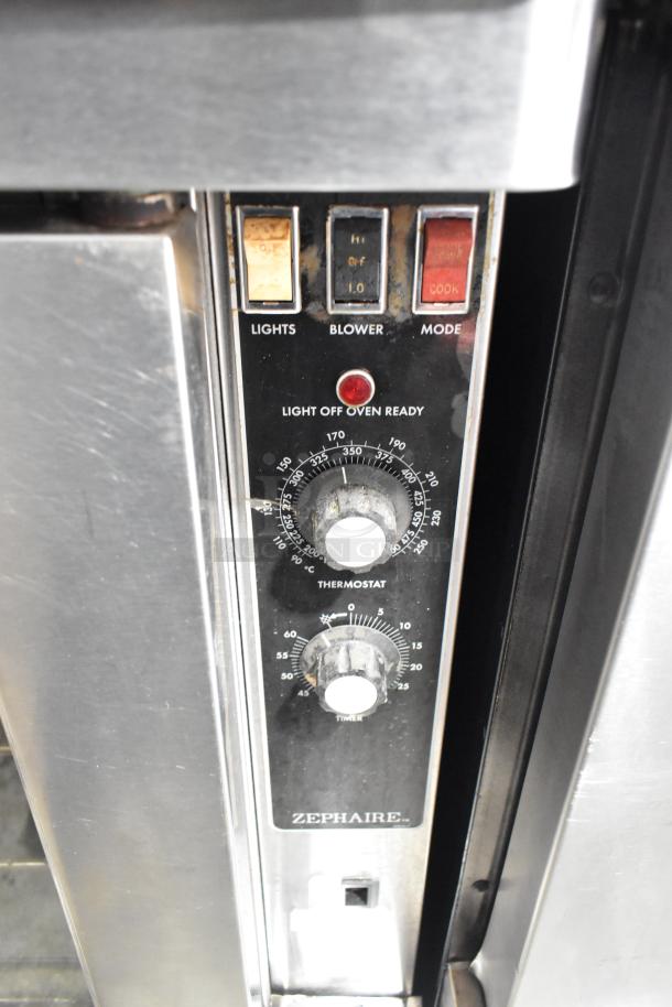Blodgett stainless steel gas convection oven with view-through doors, metal racks, thermostatic controls, and commercial casters.