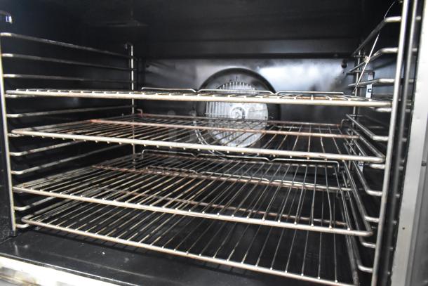 Blodgett stainless steel commercial gas convection oven interior with metal racks and fan.