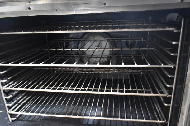 Blodgett stainless steel commercial gas convection oven with view-through doors, multiple metal racks, and thermostatic controls.
