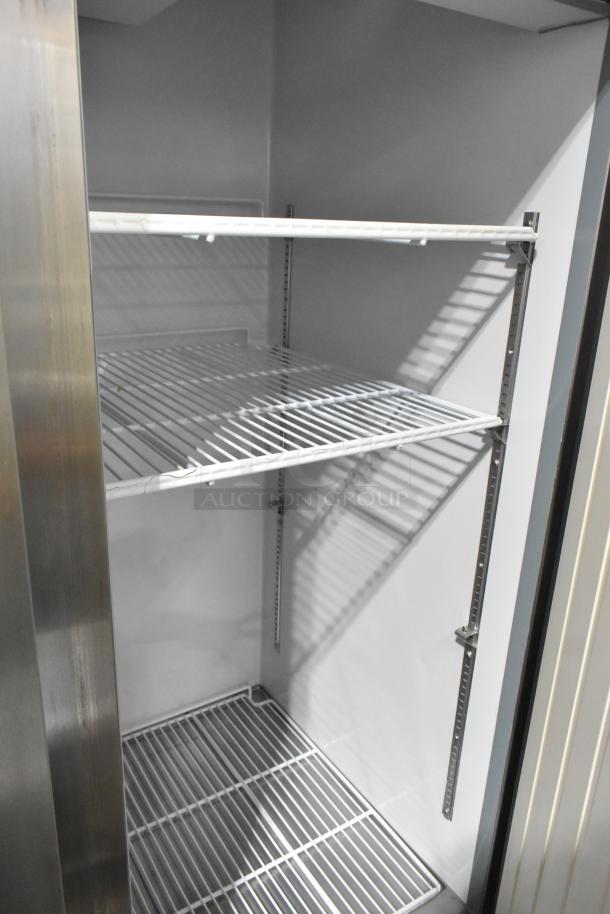 Arctic Air stainless steel 2-door commercial freezer, interior view with wire shelves, 115 volts, 1 phase, excellent condition.