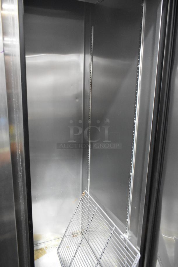 2017 True T-35 stainless steel 2-door commercial cooler interior with poly-coated racks and shelving system.