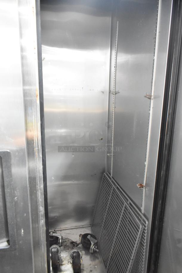 2017 True T-35 stainless steel commercial 2-door reach-in cooler, includes poly-coated racks and commercial casters. 115 volts, 1 phase.