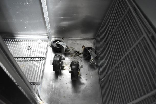 2017 True T-35 cooler interior, showing poly coated racks and four commercial casters on a stainless steel base.