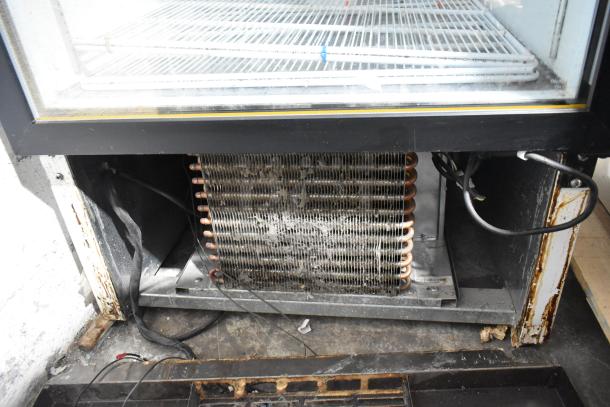 Habco SF28M commercial single door freezer, interior view showing poly-coated racks, electrical wiring, and condenser.