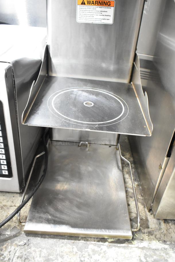 Bunn ITCB-DV commercial iced tea machine with hot water dispenser. Metal finish, countertop model, visible warning label.