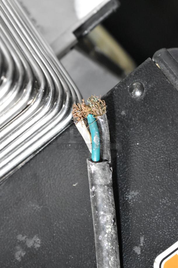 Damaged power cord on Solwave 180MW120GT commercial microwave oven, showing exposed wires, indicating need for repair.