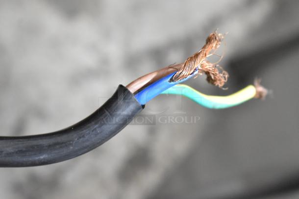 Close-up of exposed electrical wires of Beiqi BQ333 ice cream machine. Black sheath with brown, blue, and yellow-green wires visible.