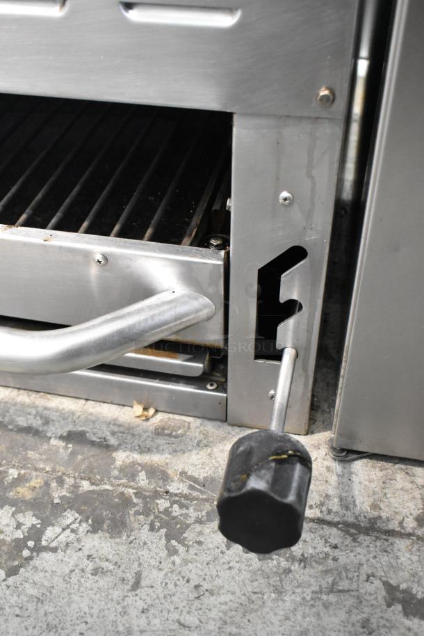 Standard Range stainless steel commercial cheese melter, adjustable handle, used condition, durable design.