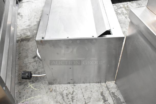 Standard Range stainless steel commercial cheese melter, in used condition, visible electrical cord and steel exterior.