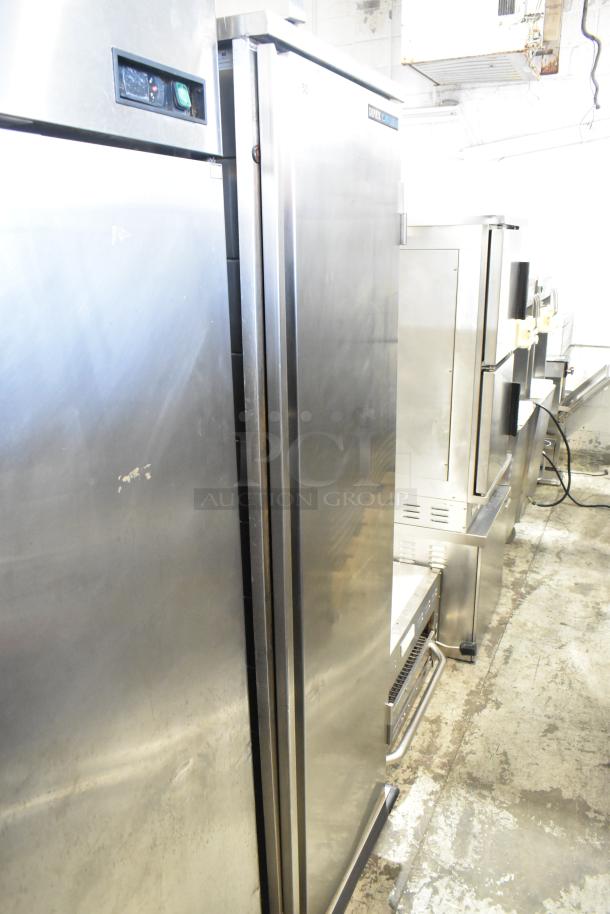 Dinex Carlisle ICTPT-24 metal pan transport rack on casters, stainless steel finish, minor surface wear, visible control panel.