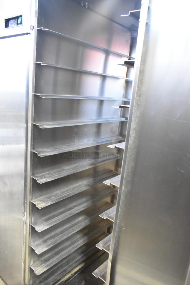Dinex Carlisle ICTPT-24 metal pan transport rack with multiple shelves, on commercial casters, in good condition.