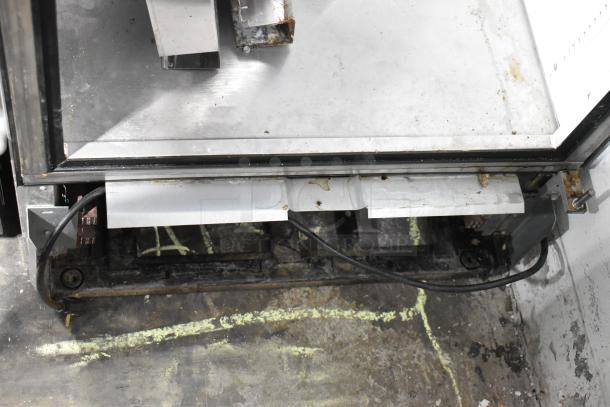 True T-19F stainless steel commercial reach-in freezer, door detached, 115 volts, 1 phase, visible wear and rust.