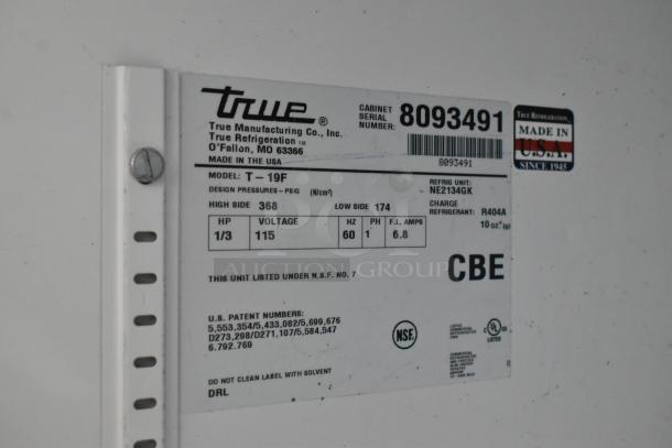 True T-19F Stainless Steel Commercial Freezer label showing model, voltage, and refrigerant details. Door needs reattachment.