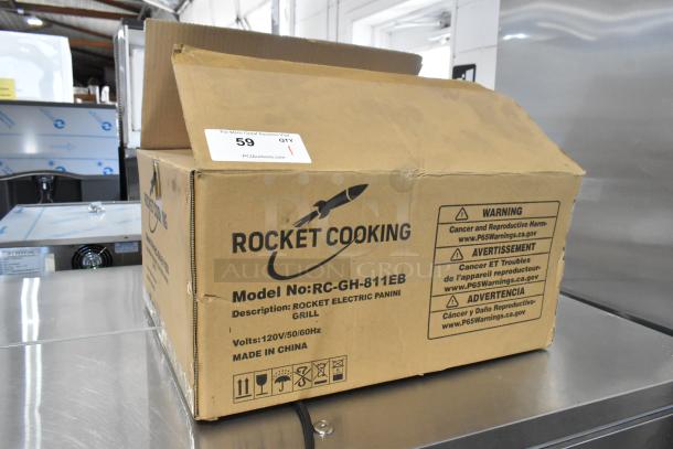 Rocket Cooking RC-GH-811EB commercial countertop panini press in box. 120V, 1 phase. Box shows model info and warnings.