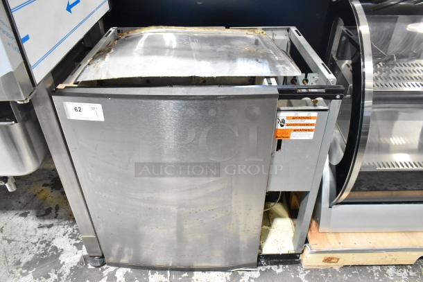 Manitowoc SY1204A stainless steel commercial ice head, 208-230 volts, 1 phase, visible wear, auction tag attached.