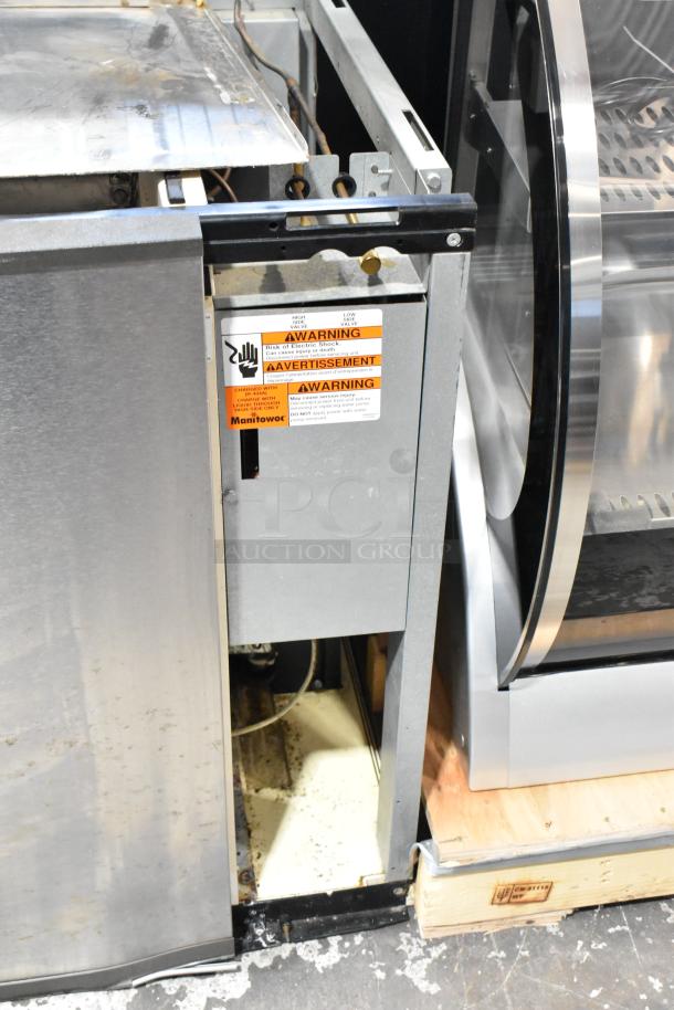Manitowoc SY1204A commercial ice head, stainless steel, 208-230V, 1 phase, warning labels visible, used condition.