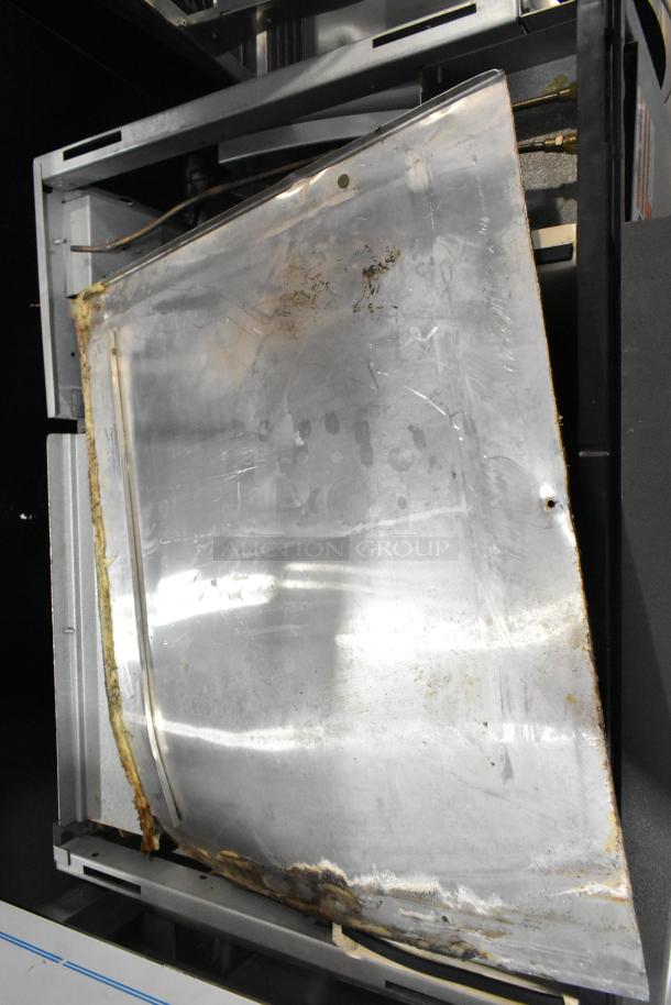 Manitowoc SY1204A stainless steel commercial ice head, 208-230V, 1 phase. Shows signs of wear and rust.