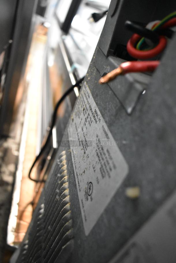 Manitowoc SY1204A stainless steel ice head, commercial-grade, 208-230 volts, 1 phase, with visible wiring and identification label.