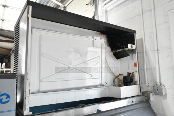 Manitowoc QY1305W commercial ice head on bin, 208-230V, 1 phase, metal casing, visible internal components, used condition.