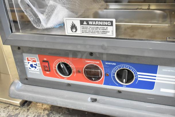 Brand new Metro C519-PFC-U proofing cabinet, stainless steel, scratch and dent, temperature/moisture controls, warning label visible.