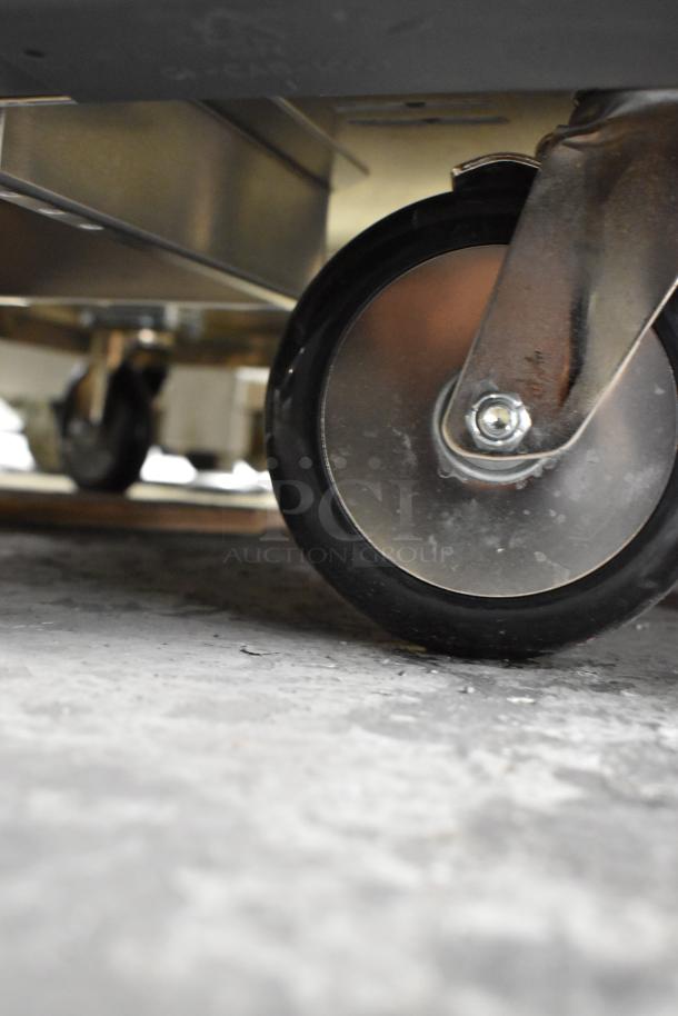 Close-up of the wheel on a 2025 Metro C519-PFC-U proofing cabinet, showing stainless steel construction and mobility feature.