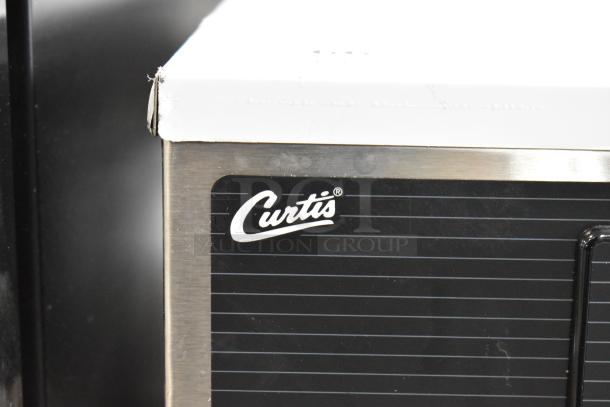 Curtis D1000GT63A000 stainless steel double coffee machine, scratch and dent, features hot water dispenser and 2 brew baskets.