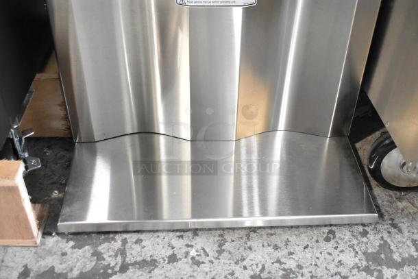 Stainless steel bottom panel of Curtis D1000GT63A000 coffee machine, showing minor scratches.