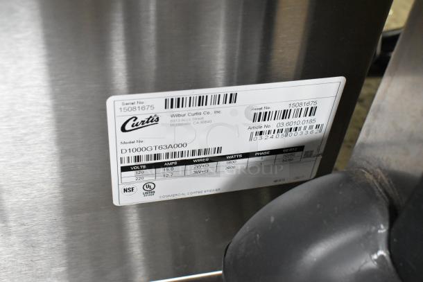 Brand new Curtis D1000GT63A000 stainless steel commercial coffee machine with hot water dispenser and two metal brew baskets.