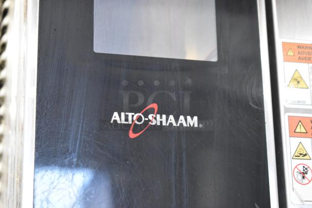 Alto Shaam AR-7T stainless steel rotisserie oven panel, featuring branding and warning labels.