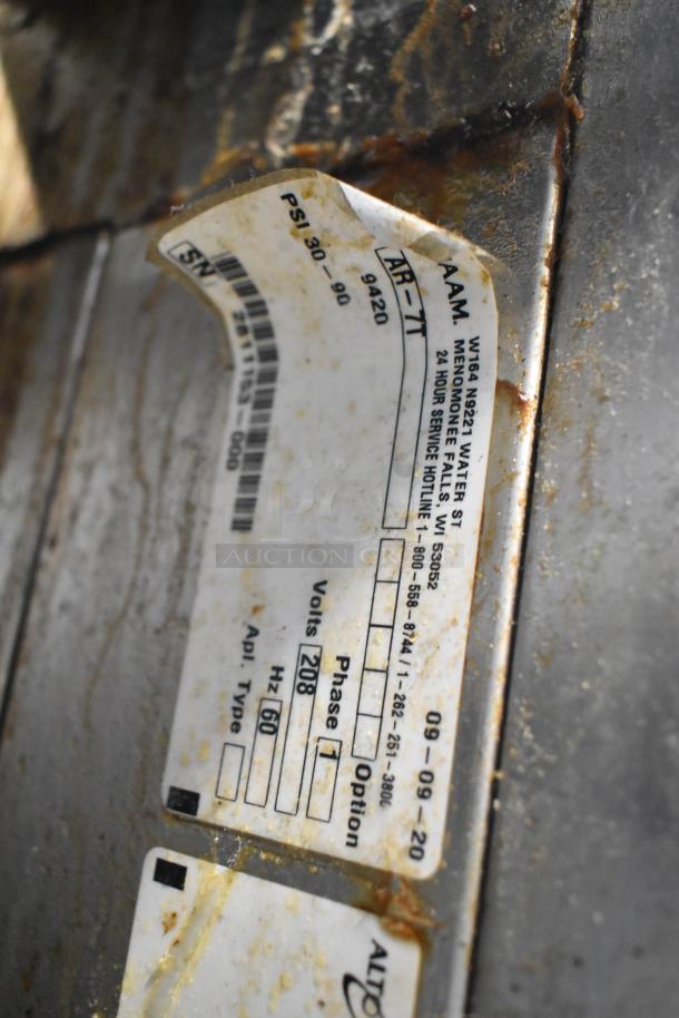 Close-up of Alto Shaam AR-7T rotisserie oven label, showing model, voltage 208, and phase 1 details.